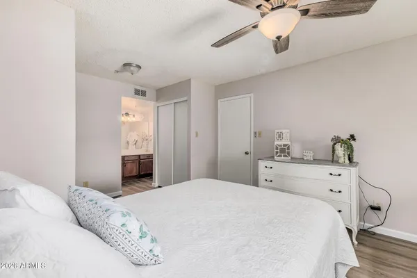 a bedroom with a bed and a chandelier