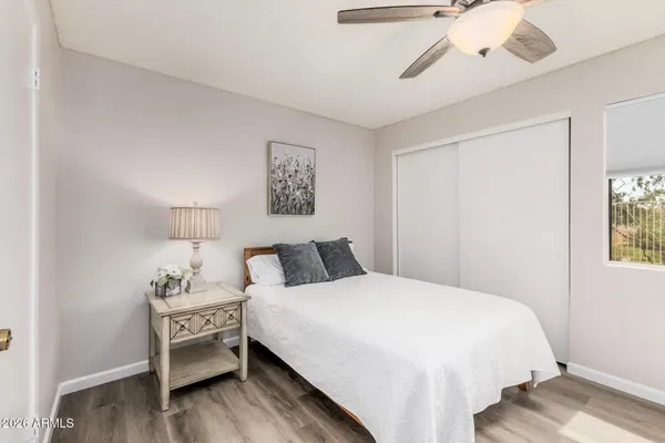 a bedroom with a bed and a window