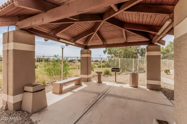 a outdoor space with the couches and dining table with the garden view