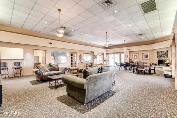 a living room with furniture and a chandelier