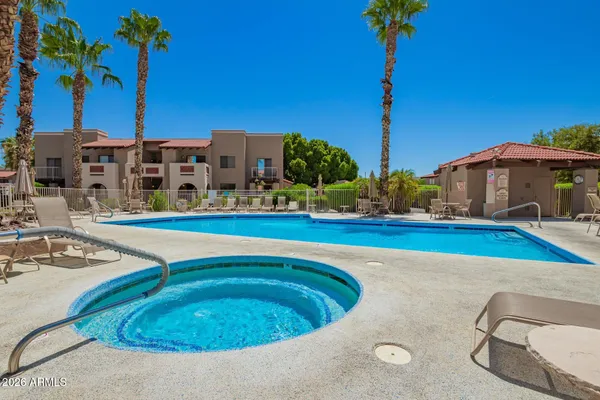 a swimming pool with outdoor seating and yard