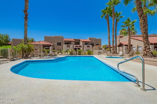 a view of a swimming pool with a lawn chairs
