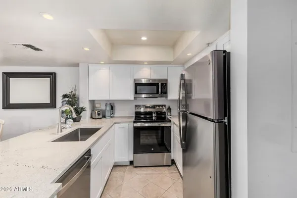 a kitchen with a sink stainless steel appliances and cabinets
