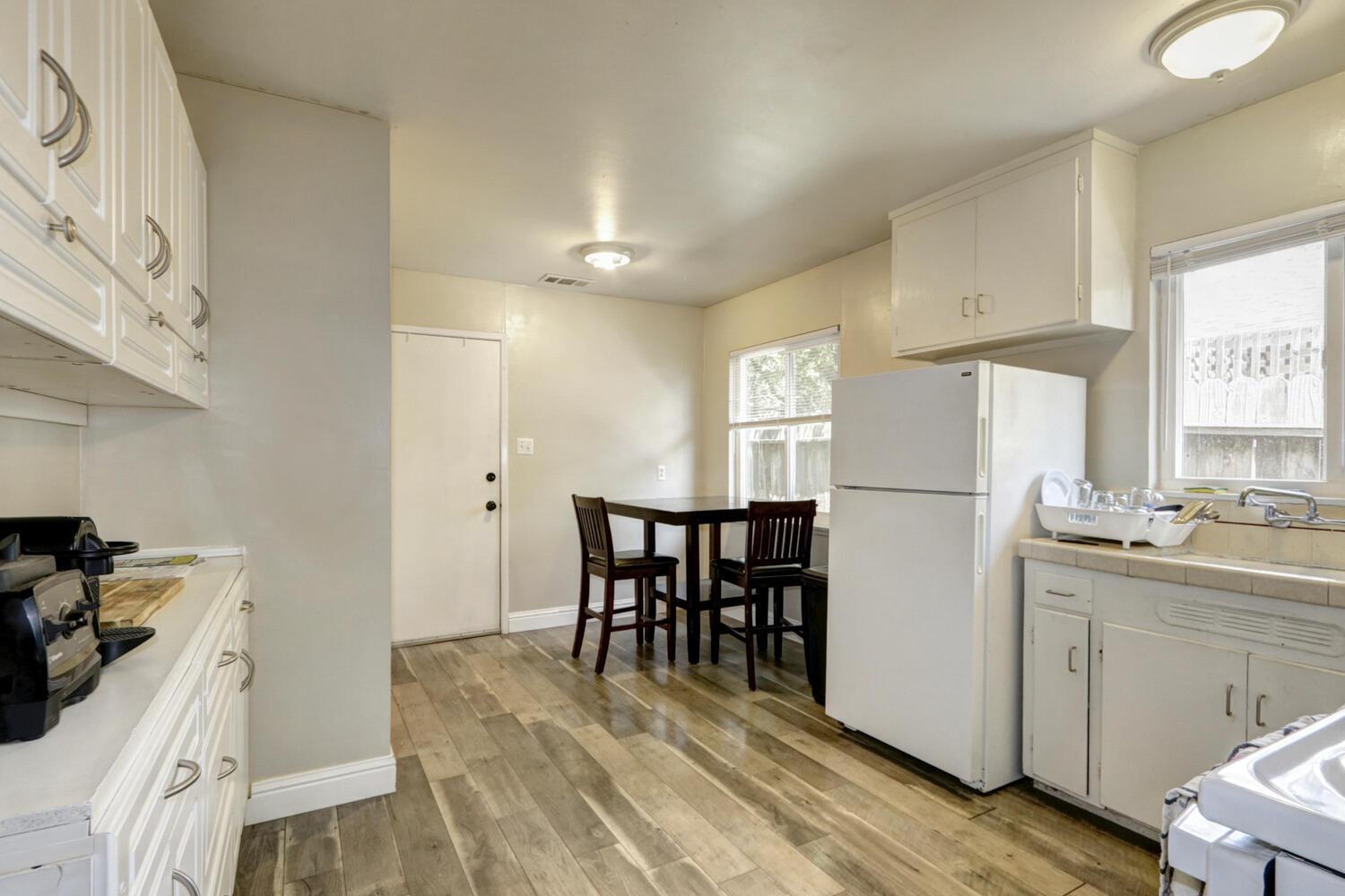 520-522 Oeste Drive Davis, CA 95616 - Photo 11 of 54 a kitchen with a sink a stove a refrigerator and white cabinets