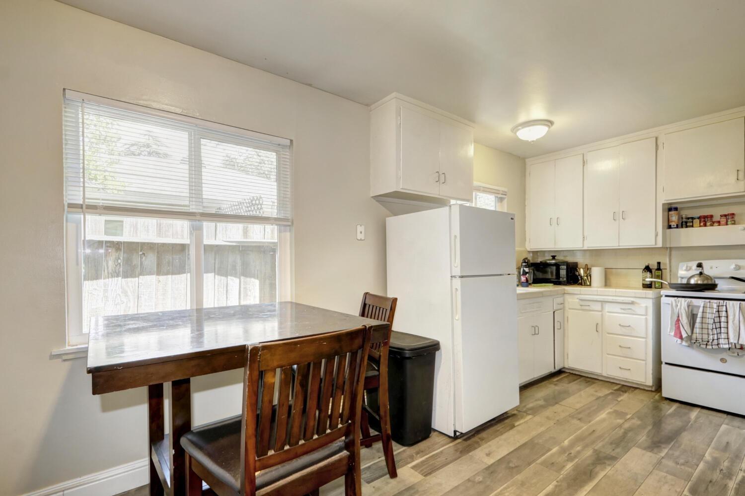 520-522 Oeste Drive Davis, CA 95616 - Photo 13 of 54 a kitchen with a table chairs refrigerator and window