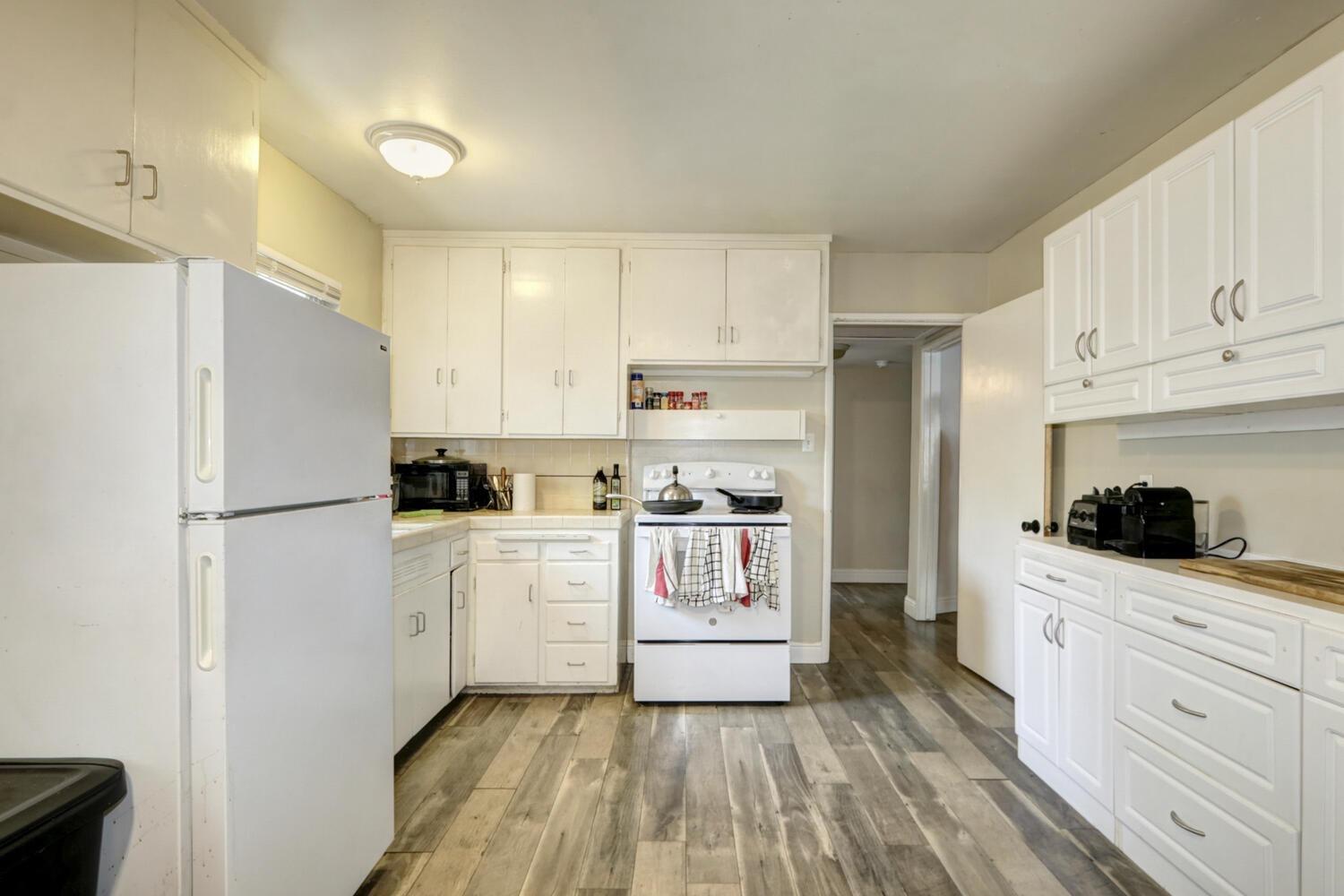 520-522 Oeste Drive Davis, CA 95616 - Photo 14 of 54 a kitchen with white cabinets and white appliances