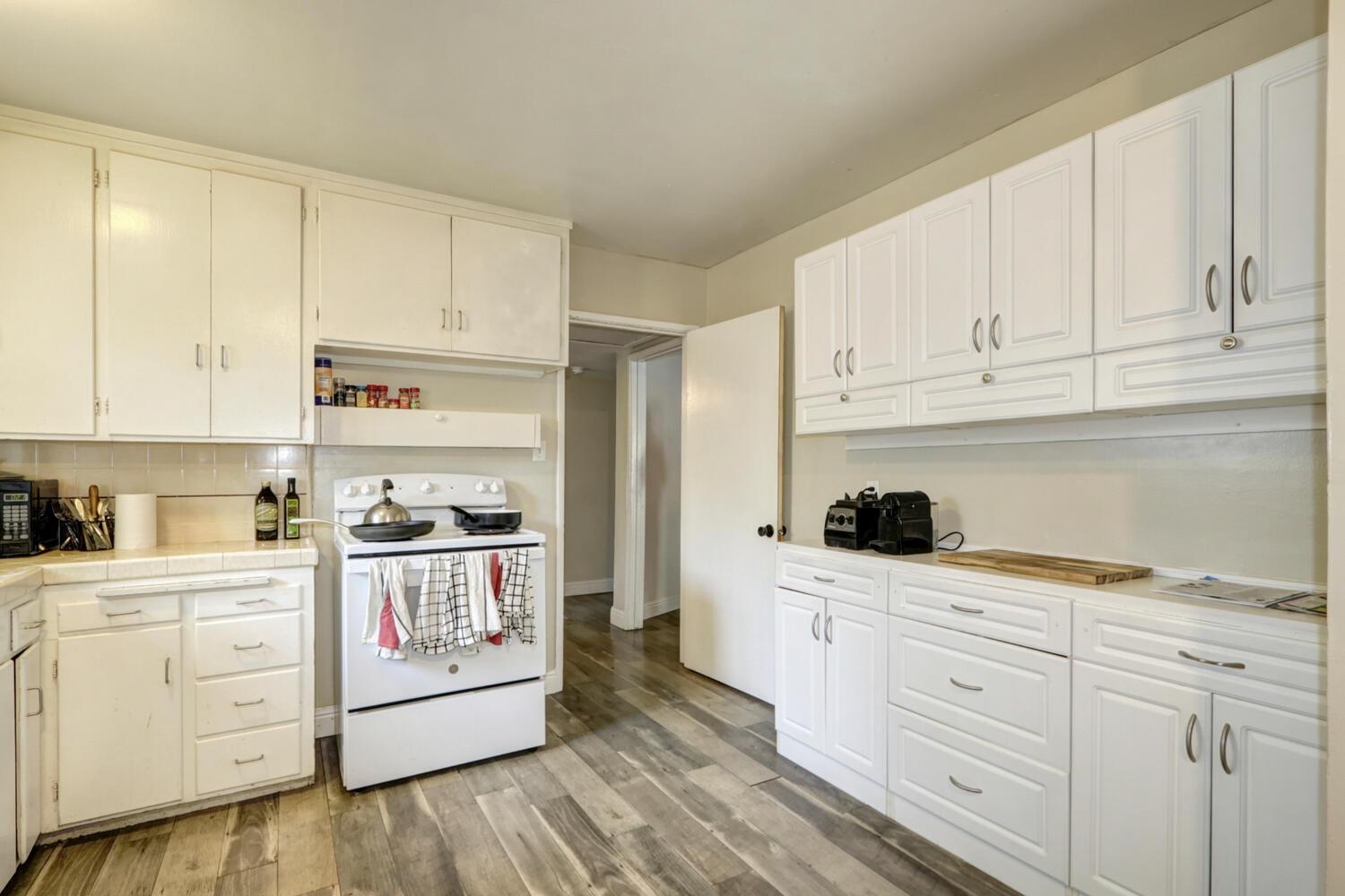520-522 Oeste Drive Davis, CA 95616 - Photo 15 of 54 a kitchen with granite countertop white cabinets and white appliances