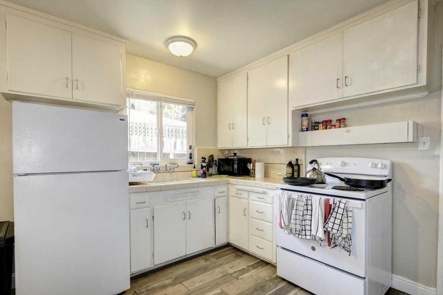 520-522 Oeste Drive Davis, CA 95616 - Photo 16 of 54 a kitchen with white cabinets sink and white appliances