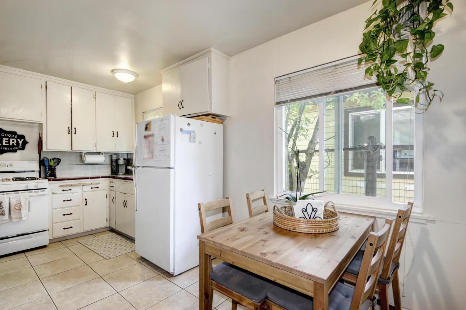 520-522 Oeste Drive Davis, CA 95616 - Photo 41 of 54 a kitchen with stainless steel appliances kitchen island granite countertop a table chairs and a refrigerator