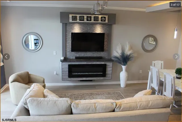 a living room with furniture a flat screen tv and a fireplace