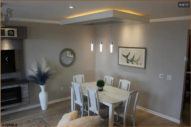 a view of a dining room with furniture and wooden floor