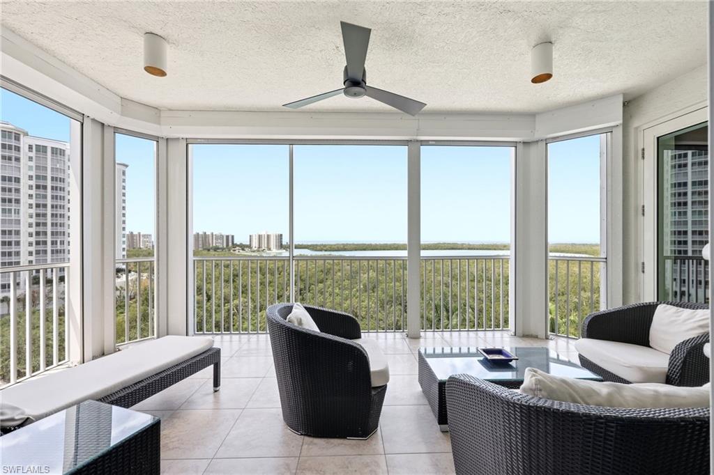 265 Indies Way, Unit 701 Naples, FL 34110 - Photo 13 of 50 a living room with furniture and a floor to ceiling window