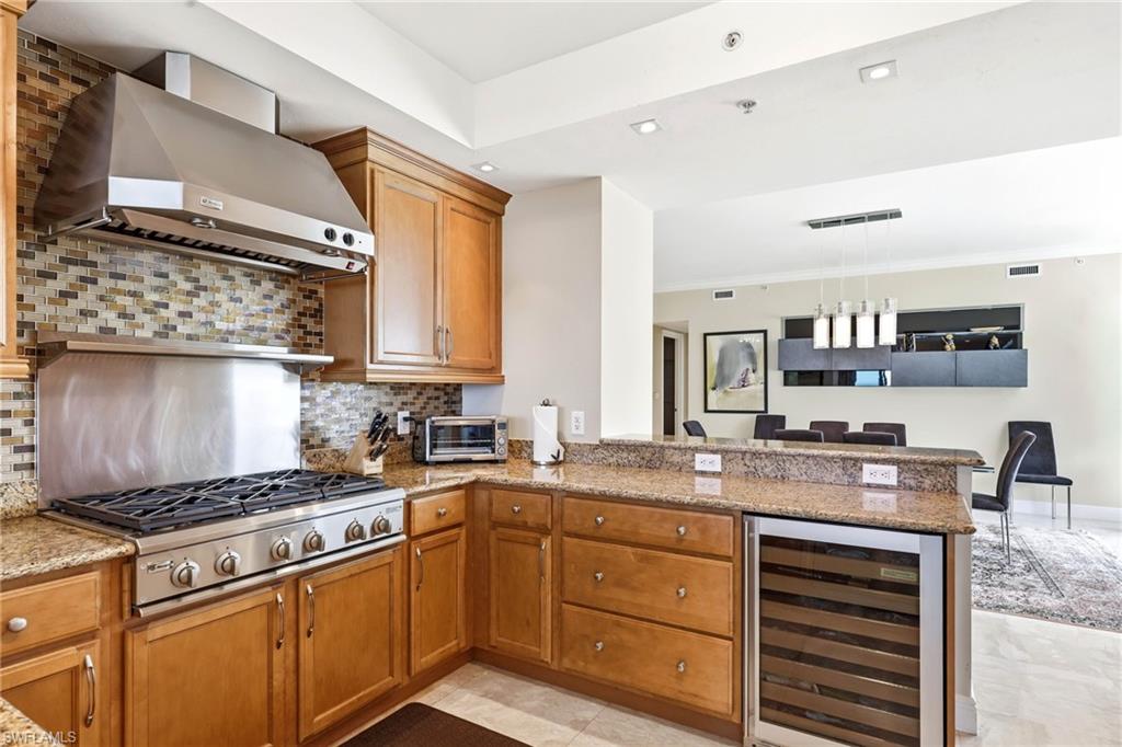 265 Indies Way, Unit 701 Naples, FL 34110 - Photo 17 of 50 a kitchen with stainless steel appliances granite countertop a stove and cabinets