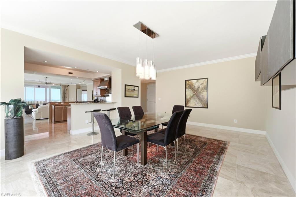 265 Indies Way, Unit 701 Naples, FL 34110 - Photo 19 of 50 a view of a dining room with furniture