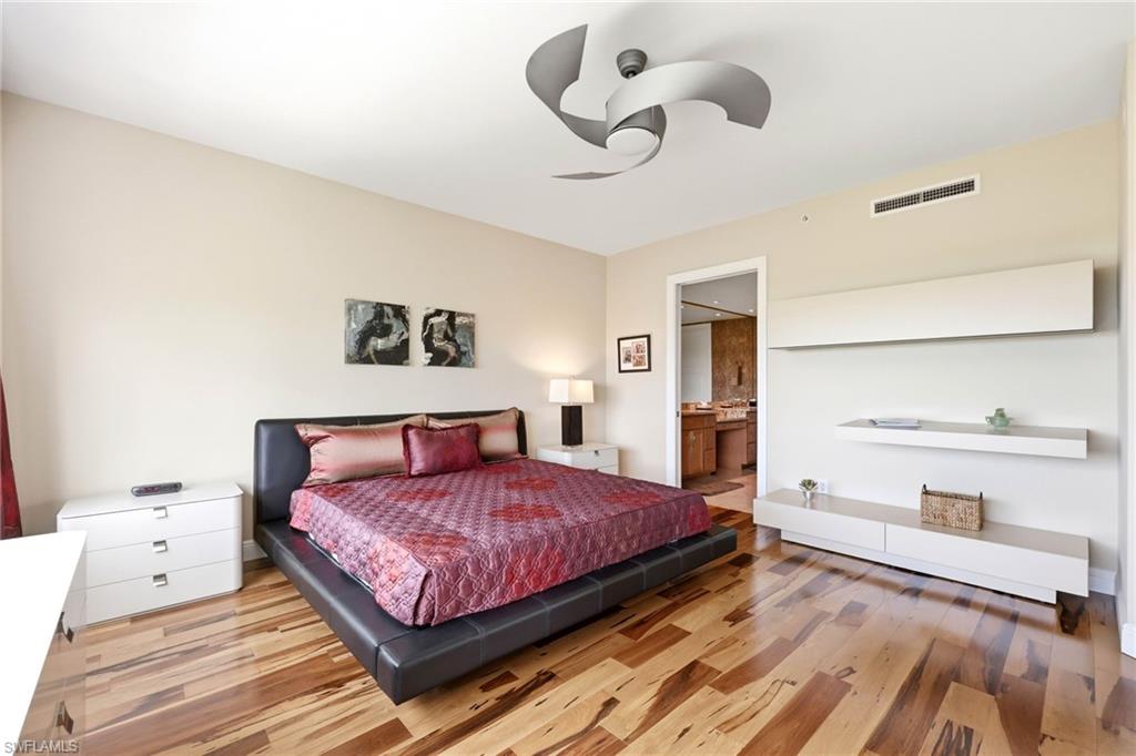 265 Indies Way, Unit 701 Naples, FL 34110 - Photo 25 of 50 a bedroom with a large bed and window