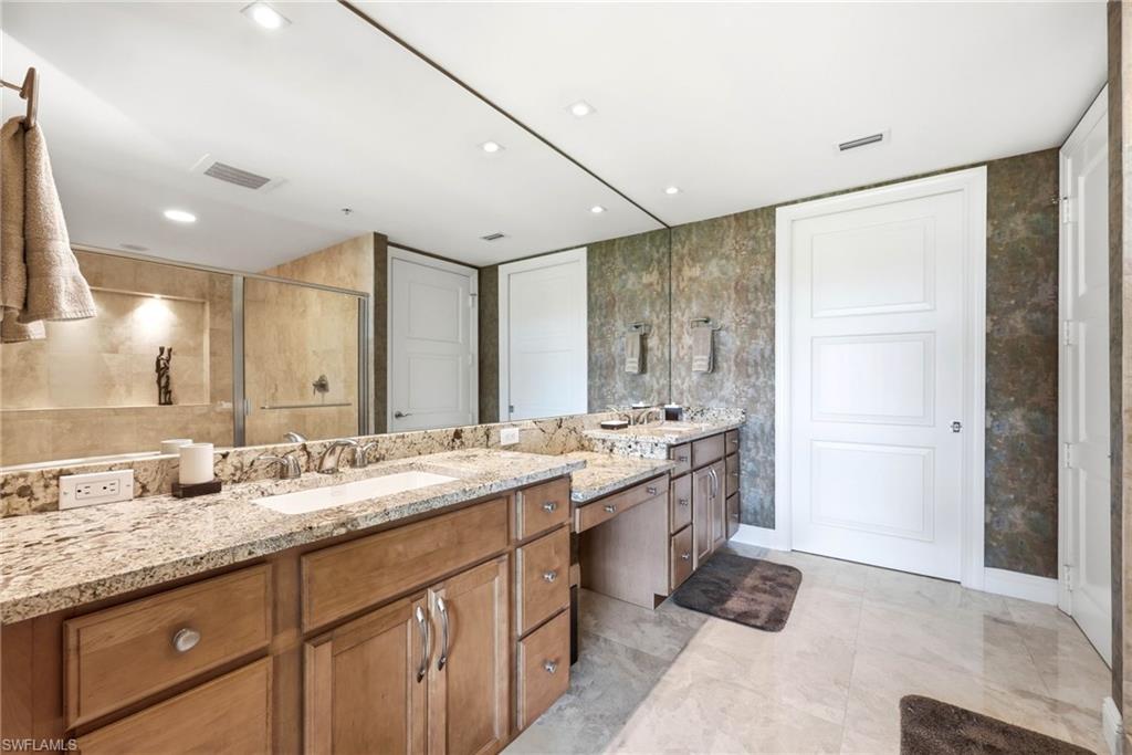 265 Indies Way, Unit 701 Naples, FL 34110 - Photo 26 of 50 a bathroom with a granite countertop sink mirror and double