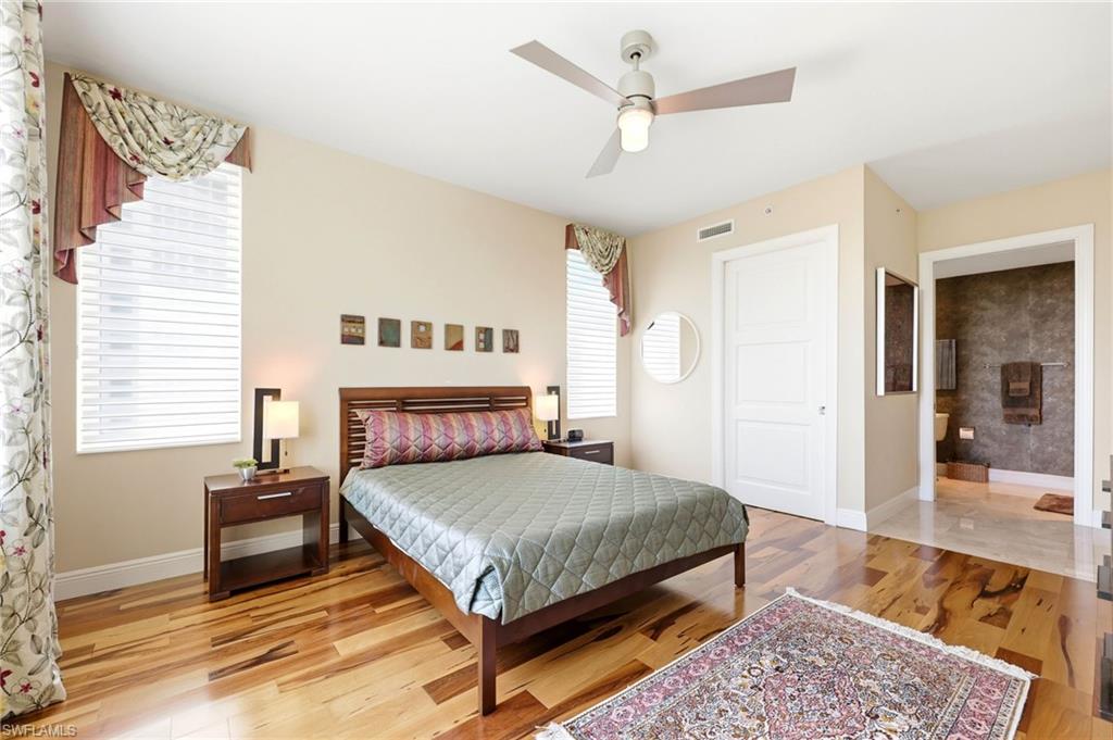 265 Indies Way, Unit 701 Naples, FL 34110 - Photo 29 of 50 a bedroom with a bed a window and a couch
