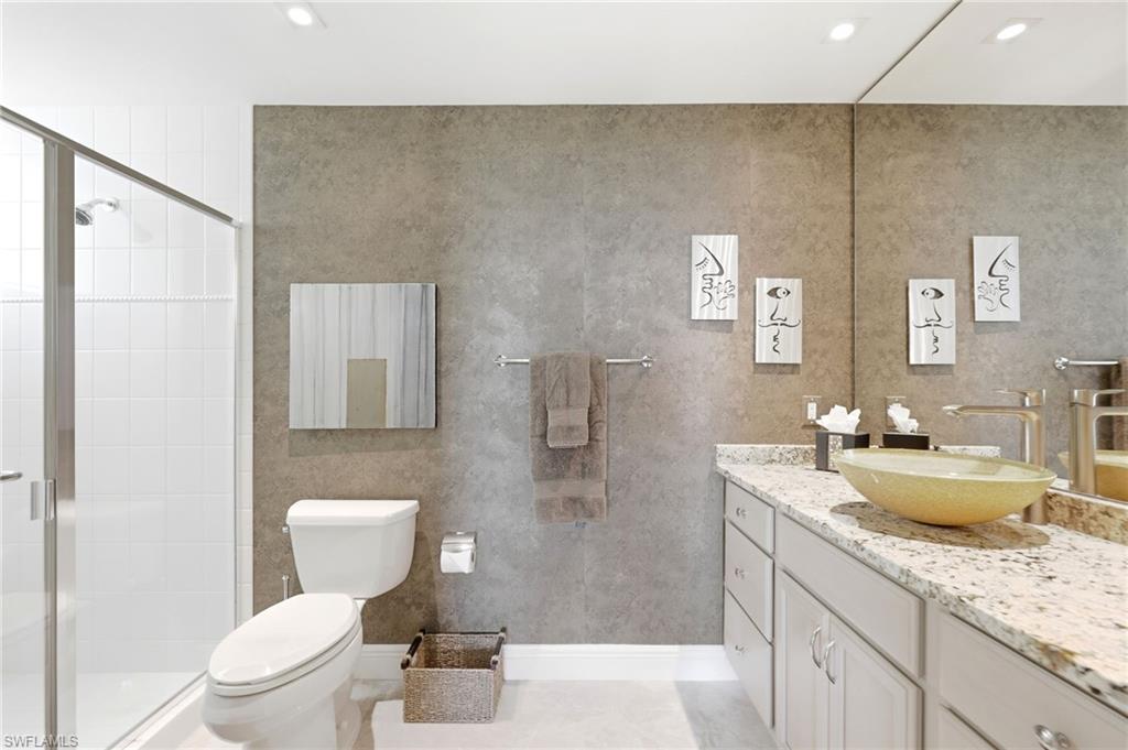265 Indies Way, Unit 701 Naples, FL 34110 - Photo 30 of 50 a bathroom with a granite countertop sink toilet and shower