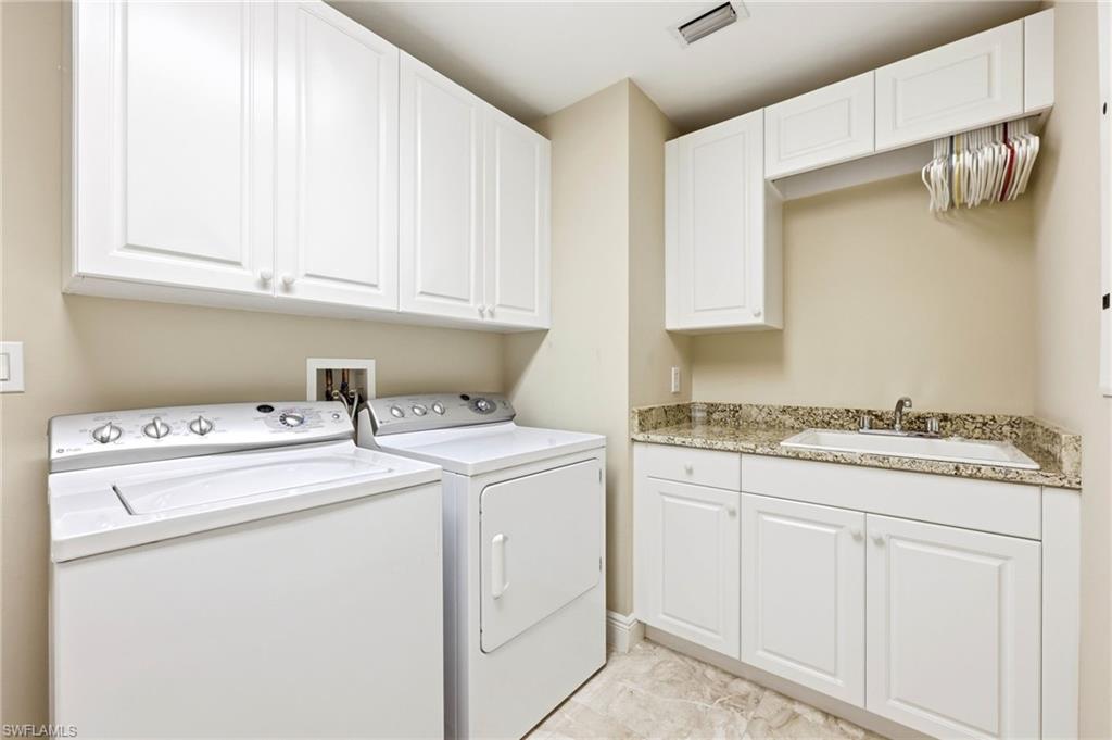 265 Indies Way, Unit 701 Naples, FL 34110 - Photo 38 of 50 a utility room with dryer and washer