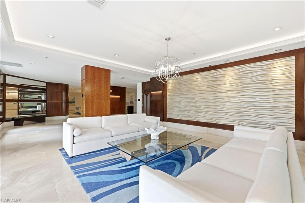 265 Indies Way, Unit 701 Naples, FL 34110 - Photo 39 of 50 a living room with furniture and a chandelier