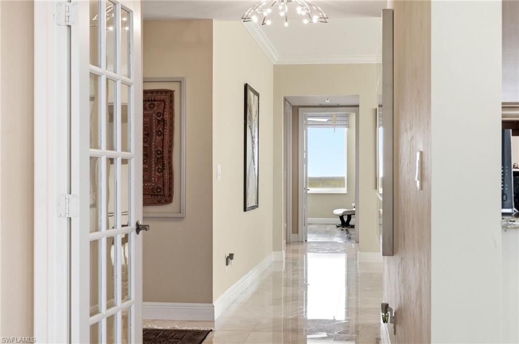 265 Indies Way, Unit 701 Naples, FL 34110 - Photo 6 of 50 a view of a bathroom from a hallway