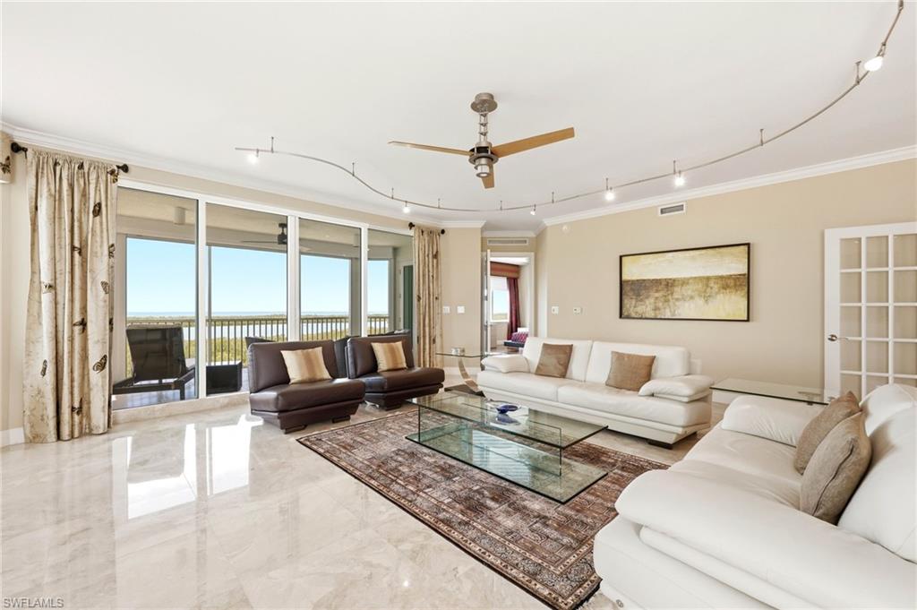 265 Indies Way, Unit 701 Naples, FL 34110 - Photo 8 of 50 a living room with furniture and a large window