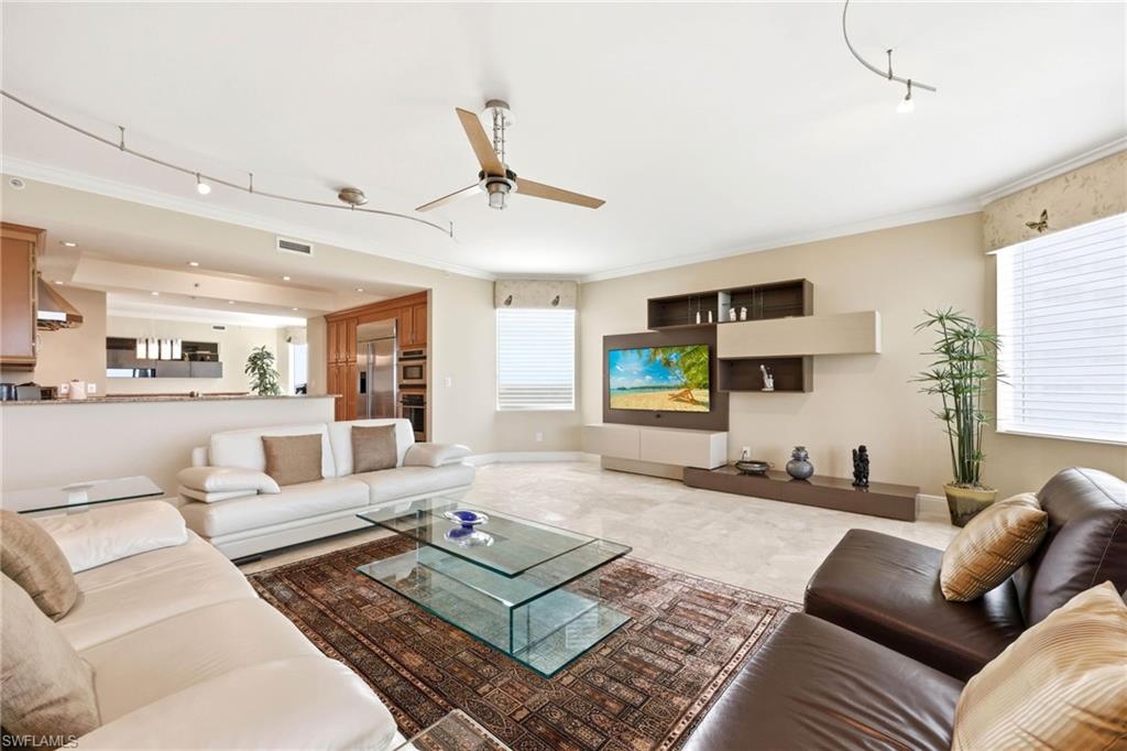 265 Indies Way, Unit 701 Naples, FL 34110 - Photo 10 of 50 a living room with furniture and a flat screen tv