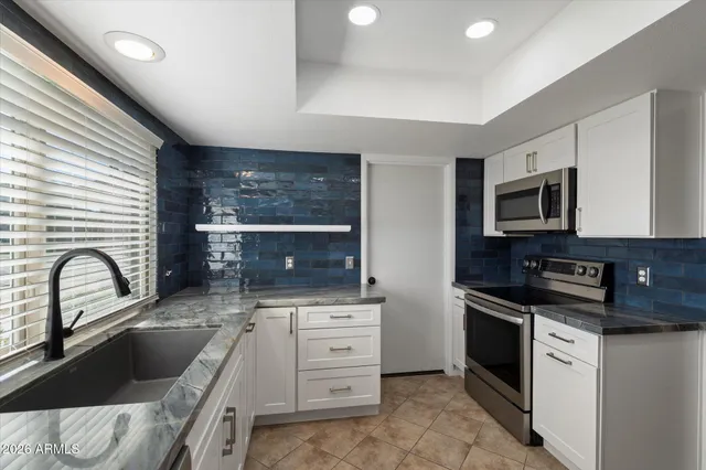 a kitchen with a stove a sink and a microwave