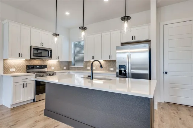 a view of kitchen and hall with wooden floor