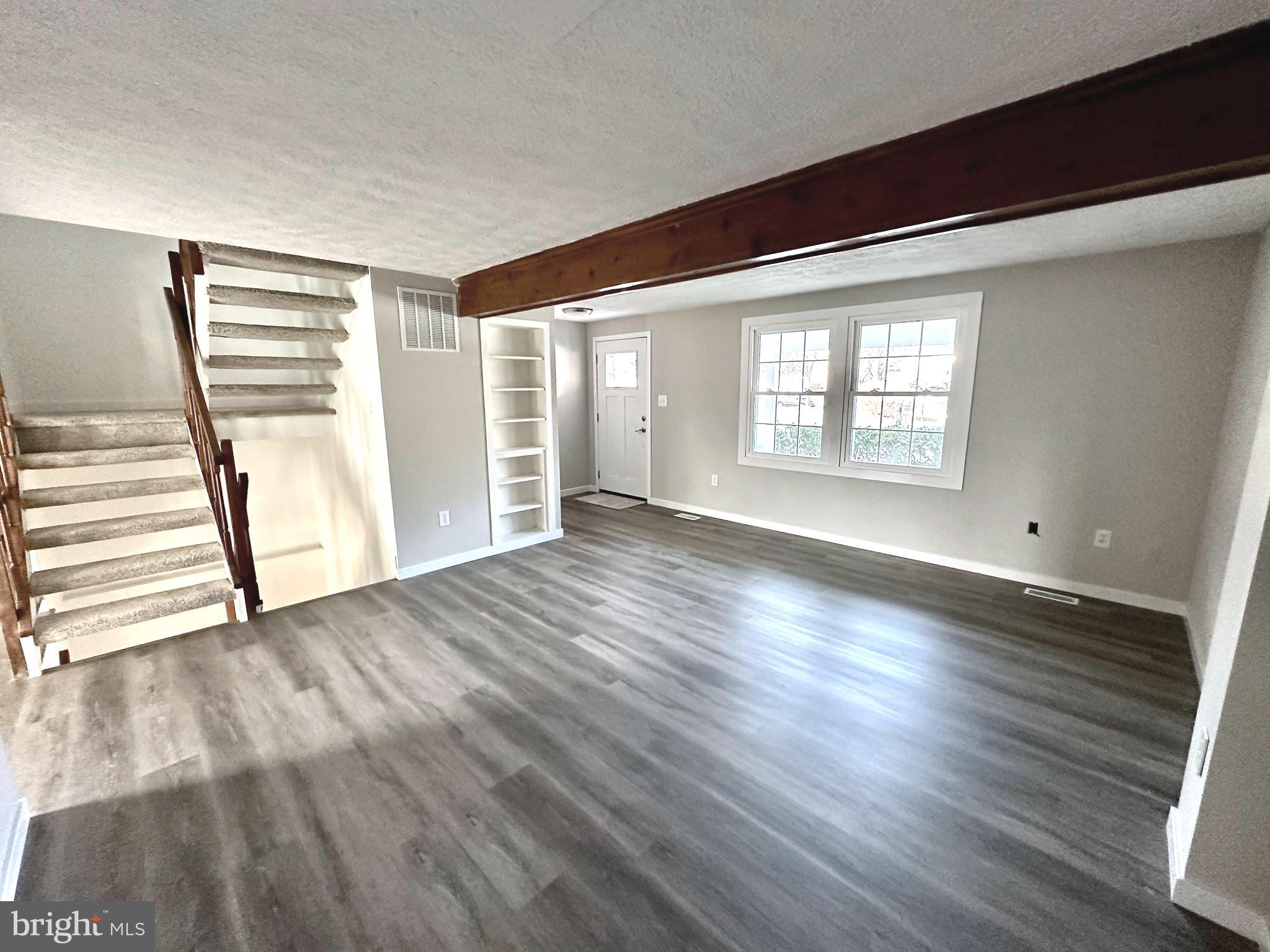 1776 Springfield Lane Frederick, MD 21702 - Photo 13 of 56 an empty room with wooden floor and windows