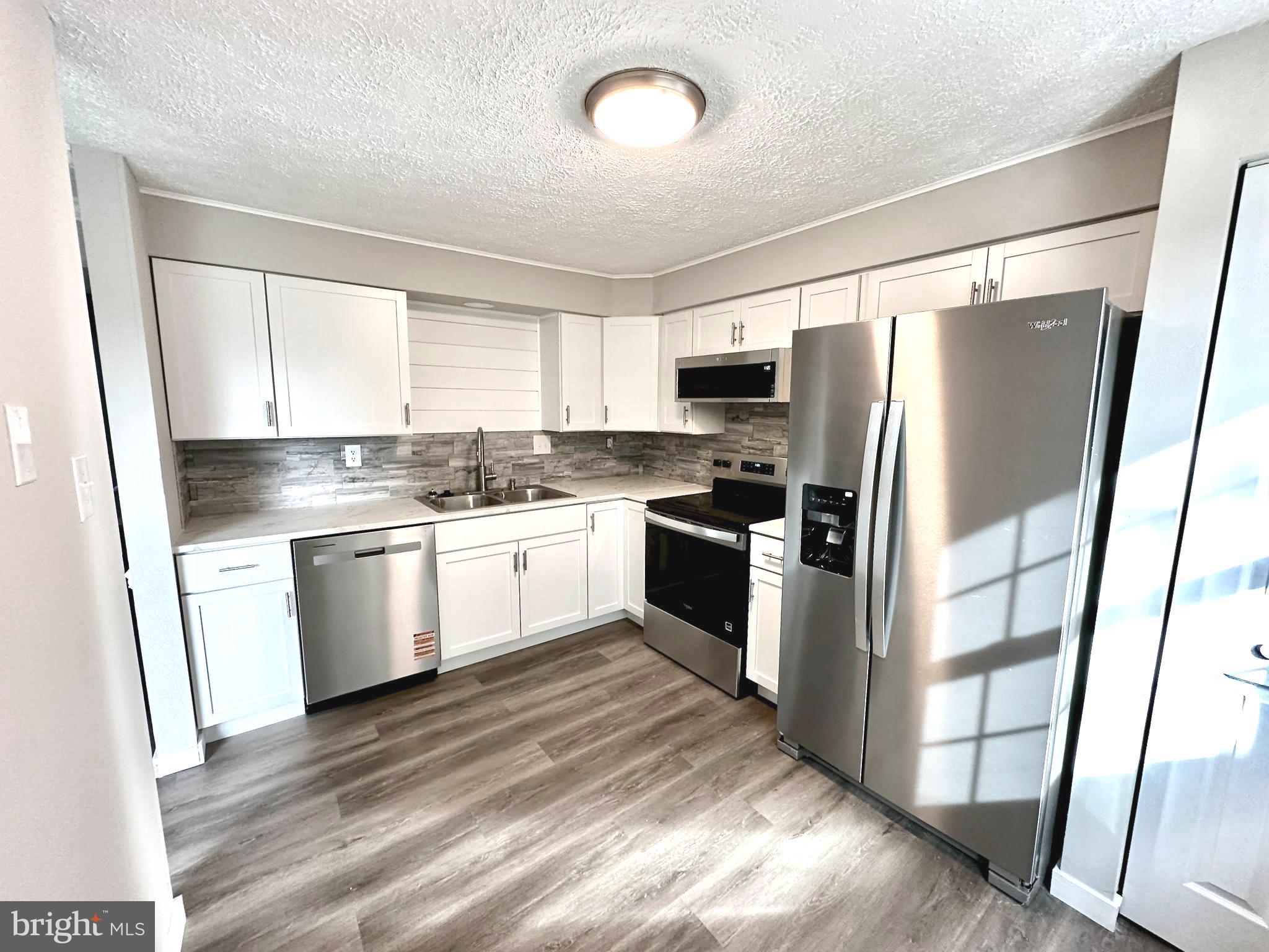 1776 Springfield Lane Frederick, MD 21702 - Photo 15 of 56 a kitchen with a refrigerator a sink and a stove