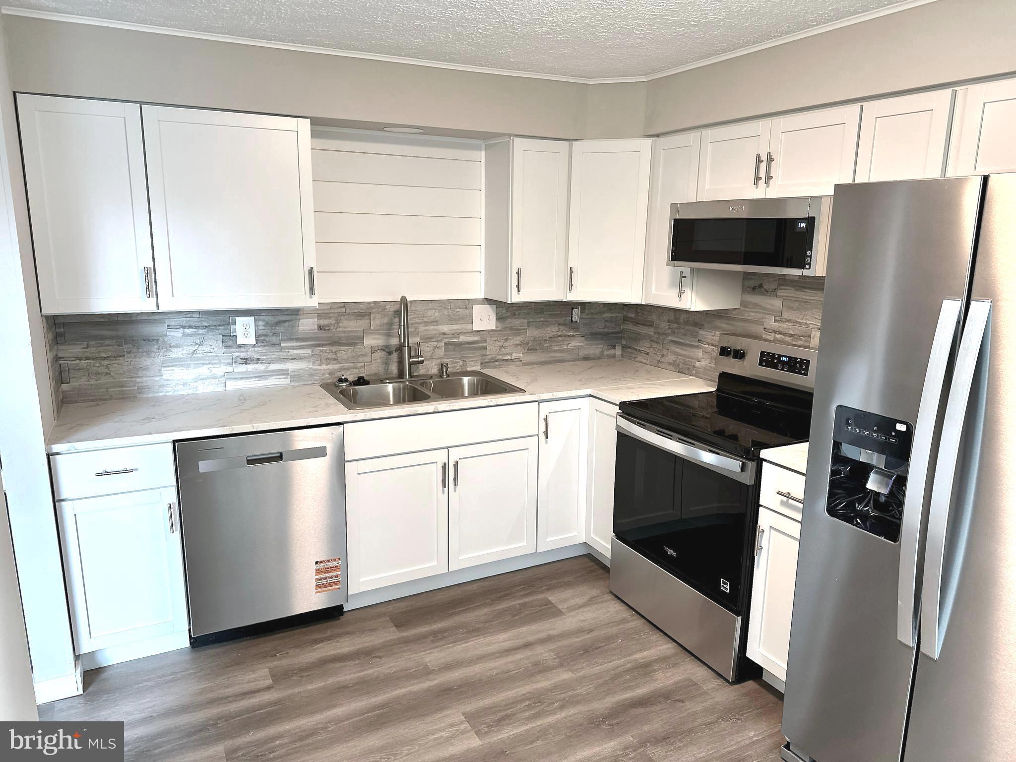 1776 Springfield Lane Frederick, MD 21702 - Photo 19 of 56 a kitchen with stainless steel appliances a refrigerator sink and microwave