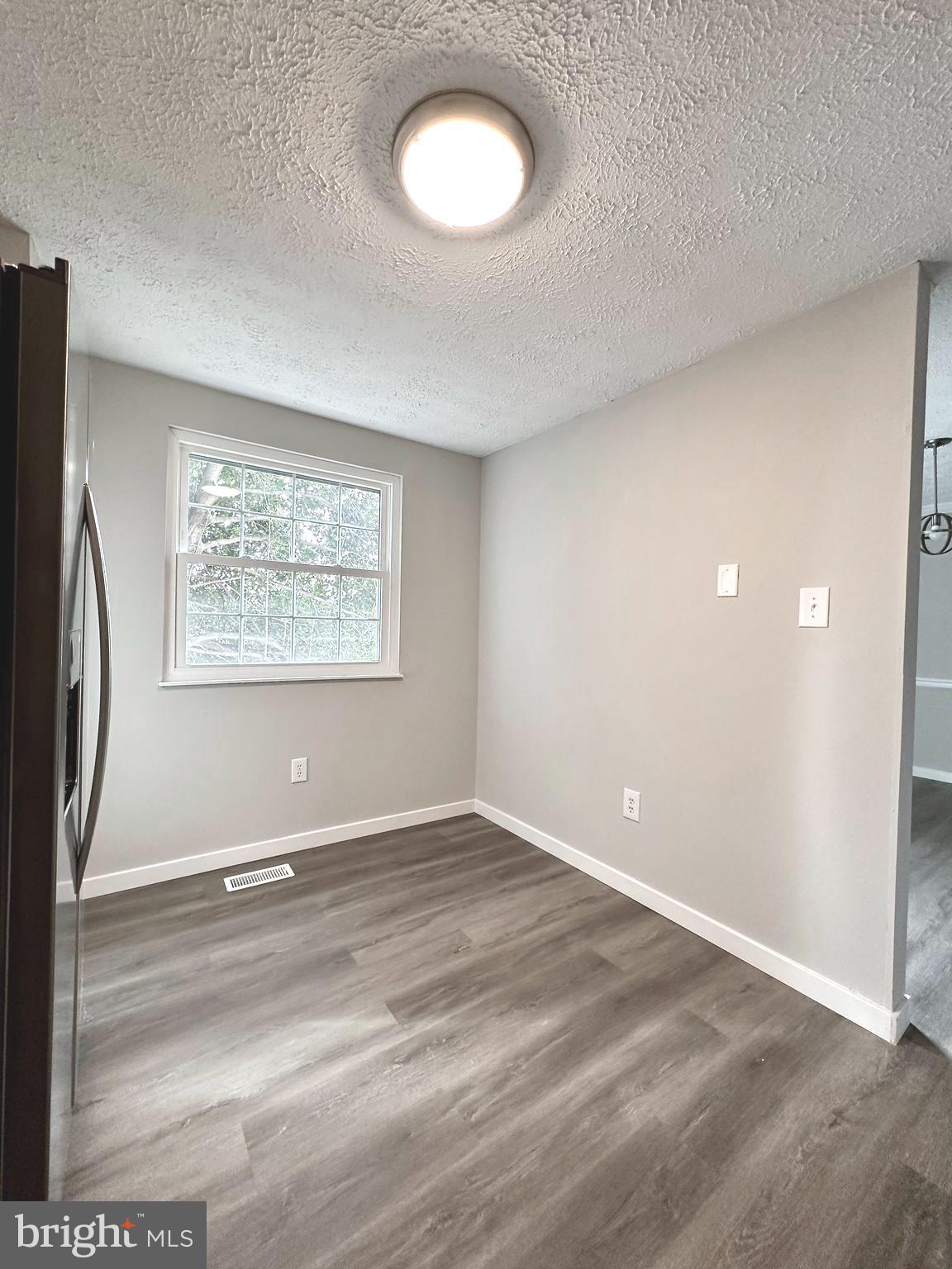 1776 Springfield Lane Frederick, MD 21702 - Photo 20 of 56 an empty room with wooden floor and windows