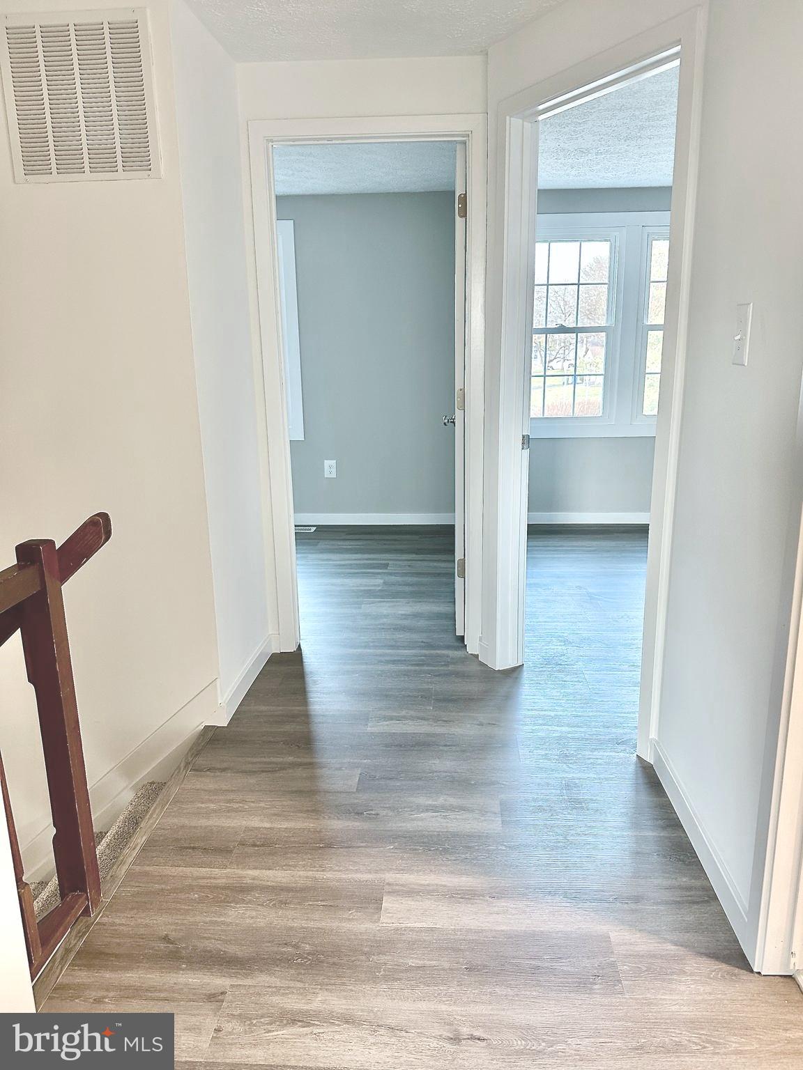 1776 Springfield Lane Frederick, MD 21702 - Photo 24 of 56 a view of a hallway with wooden floor and staircase