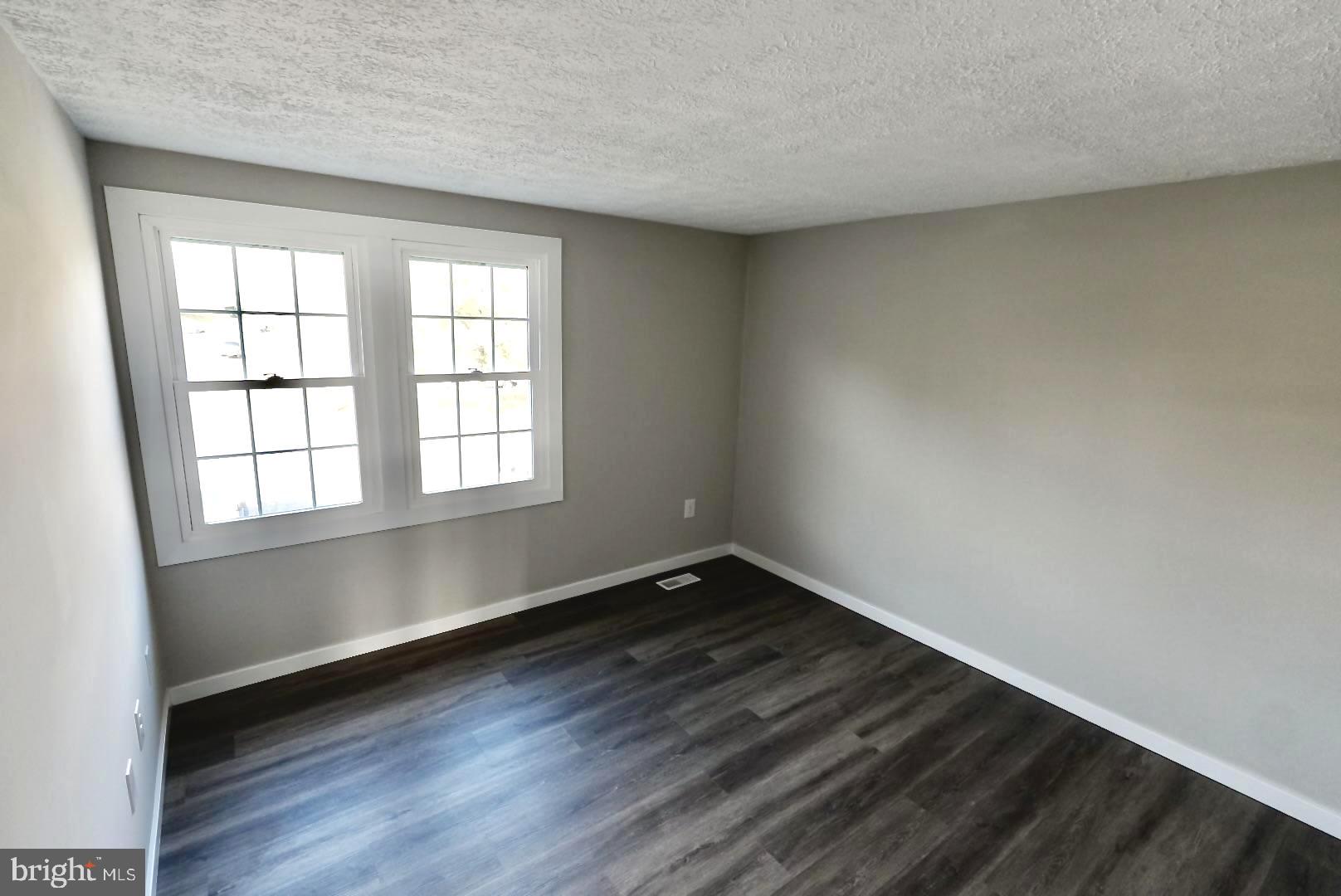 1776 Springfield Lane Frederick, MD 21702 - Photo 25 of 56 an empty room with wooden floor and windows