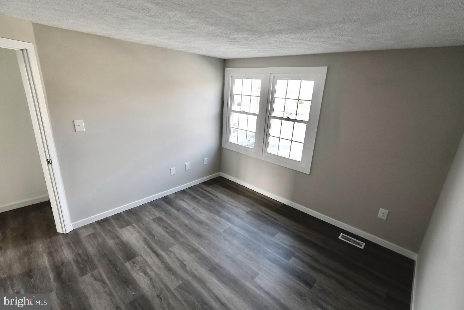 1776 Springfield Lane Frederick, MD 21702 - Photo 26 of 56 an empty room with wooden floor and windows