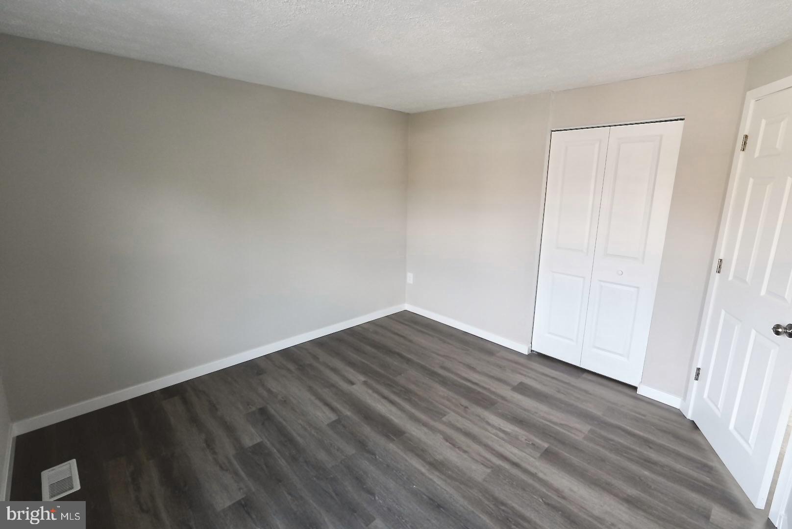 1776 Springfield Lane Frederick, MD 21702 - Photo 27 of 56 a view of an empty room with wooden floor