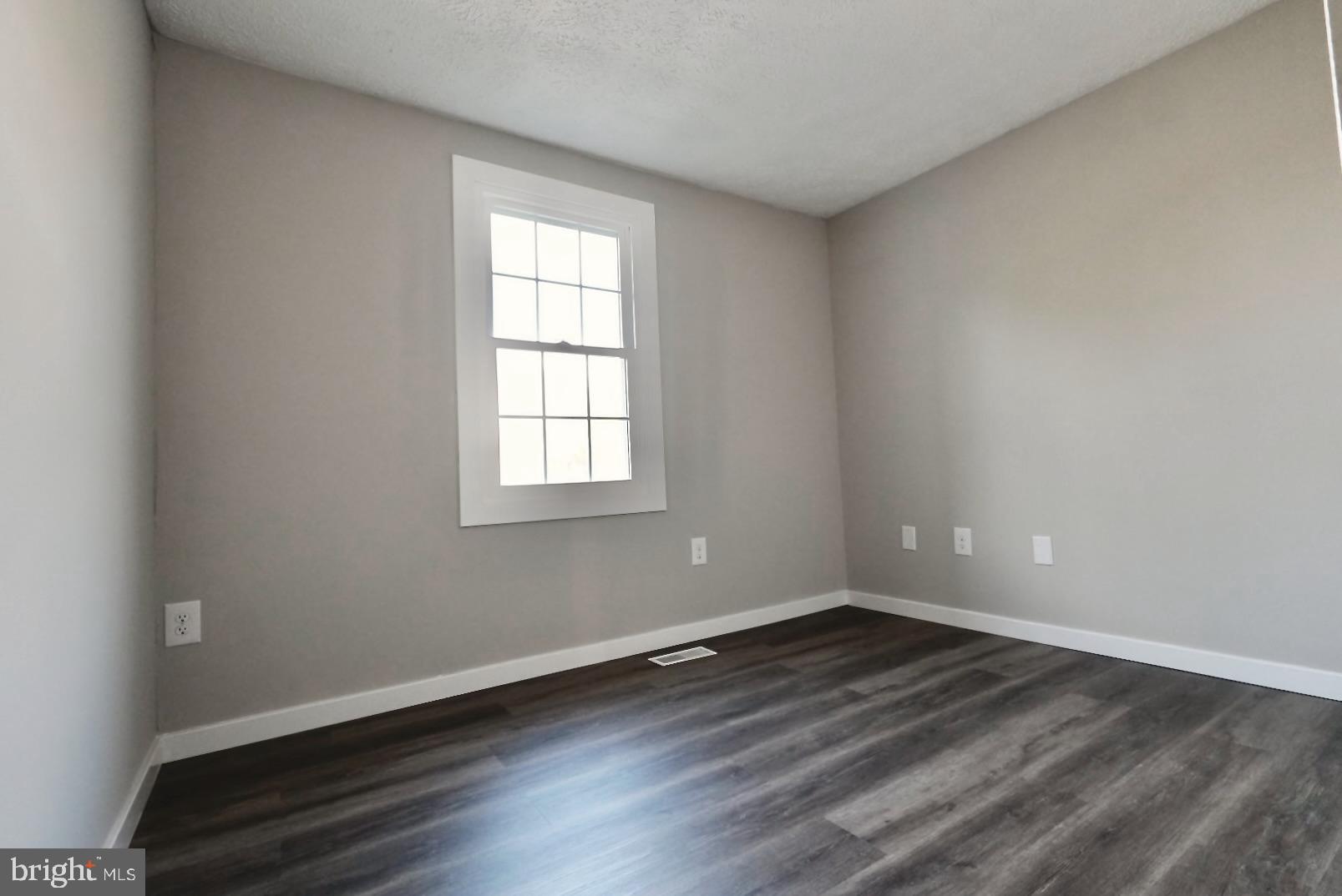 1776 Springfield Lane Frederick, MD 21702 - Photo 30 of 56 an empty room with wooden floor and windows