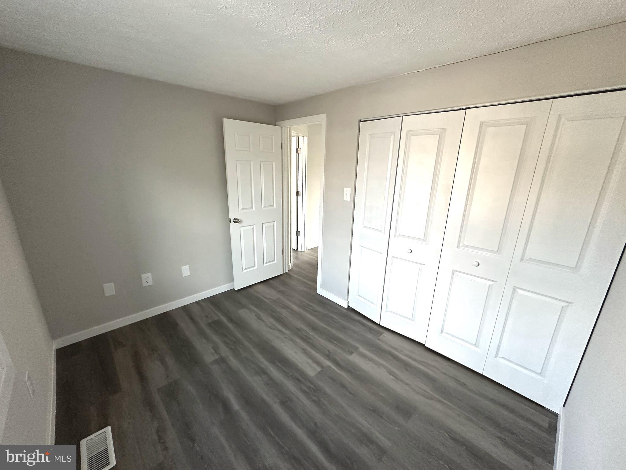 1776 Springfield Lane Frederick, MD 21702 - Photo 31 of 56 a view of an empty room with wooden floor