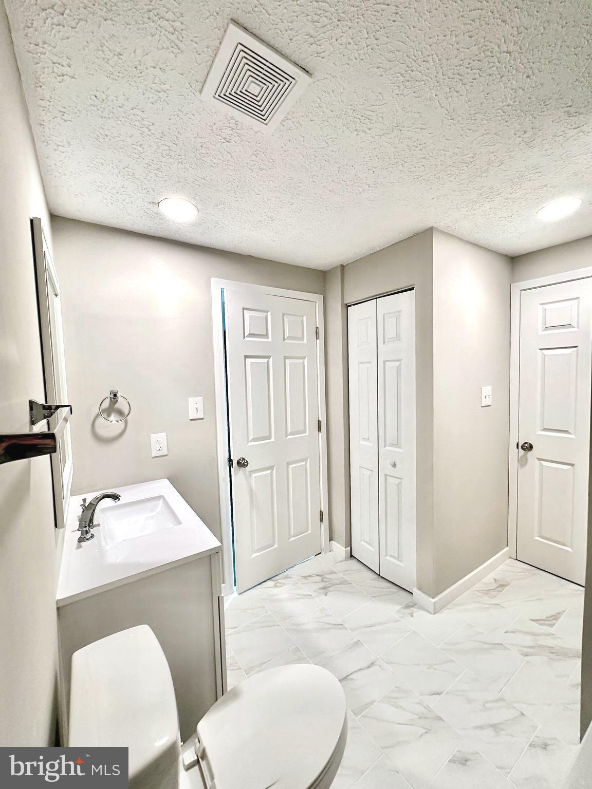 1776 Springfield Lane Frederick, MD 21702 - Photo 34 of 56 a bathroom with a granite countertop sink toilet a large mirror and shower