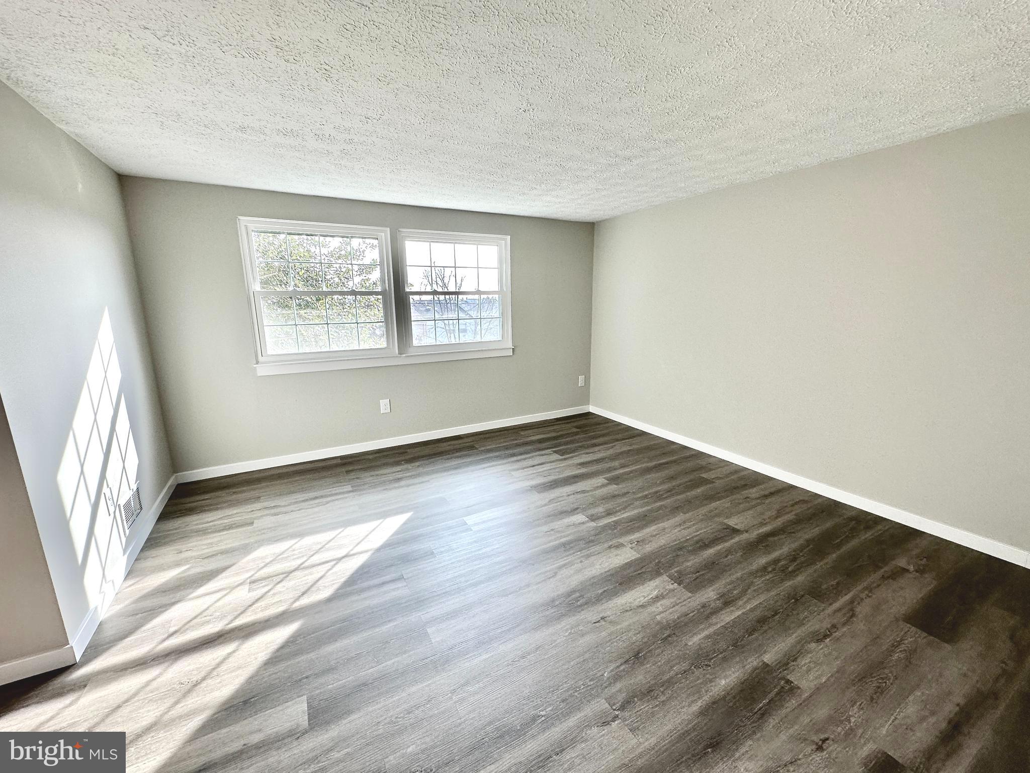 1776 Springfield Lane Frederick, MD 21702 - Photo 37 of 56 a view of an empty room with wooden floor and a window
