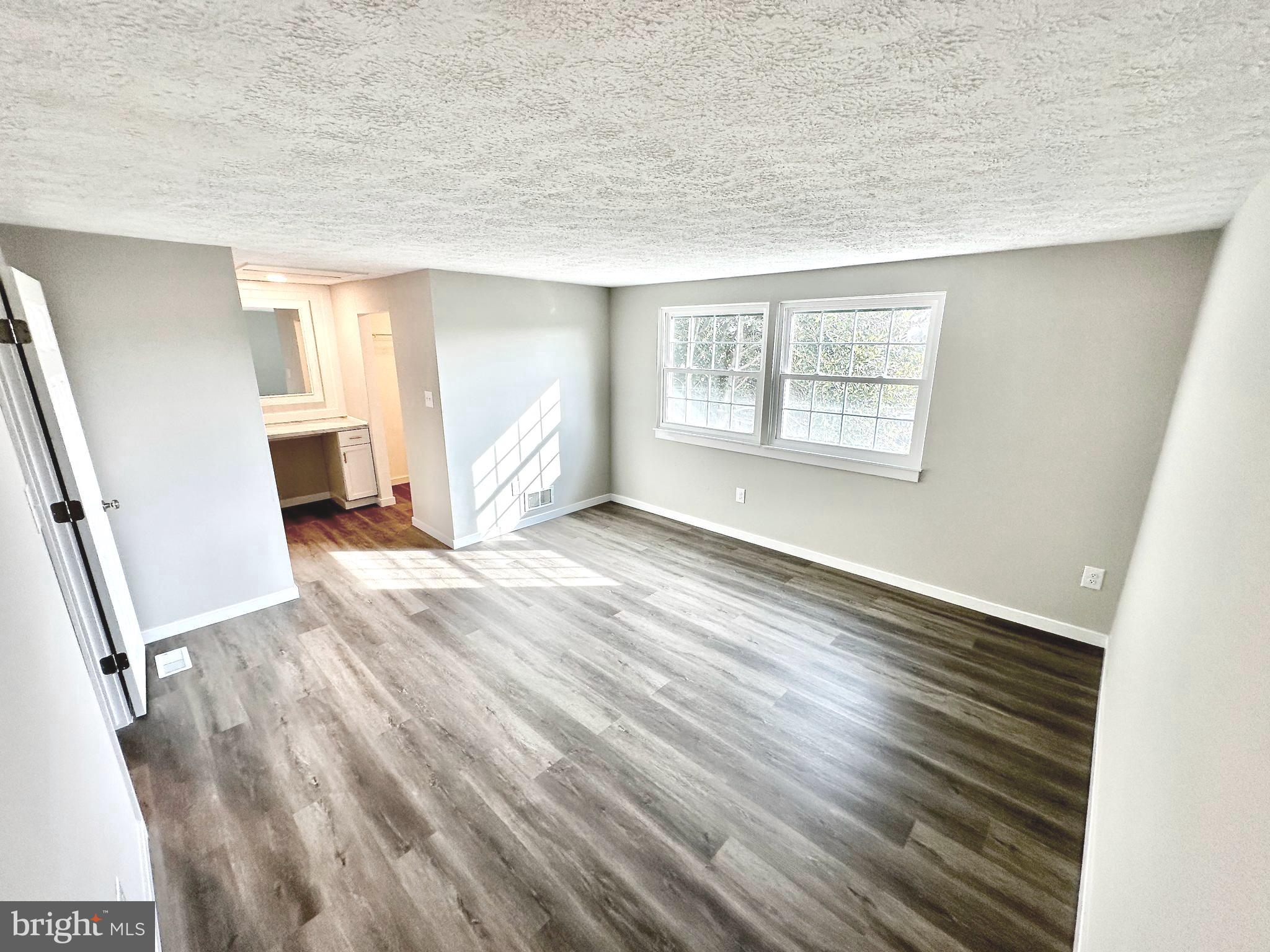 1776 Springfield Lane Frederick, MD 21702 - Photo 38 of 56 wooden floor in an empty room with a window