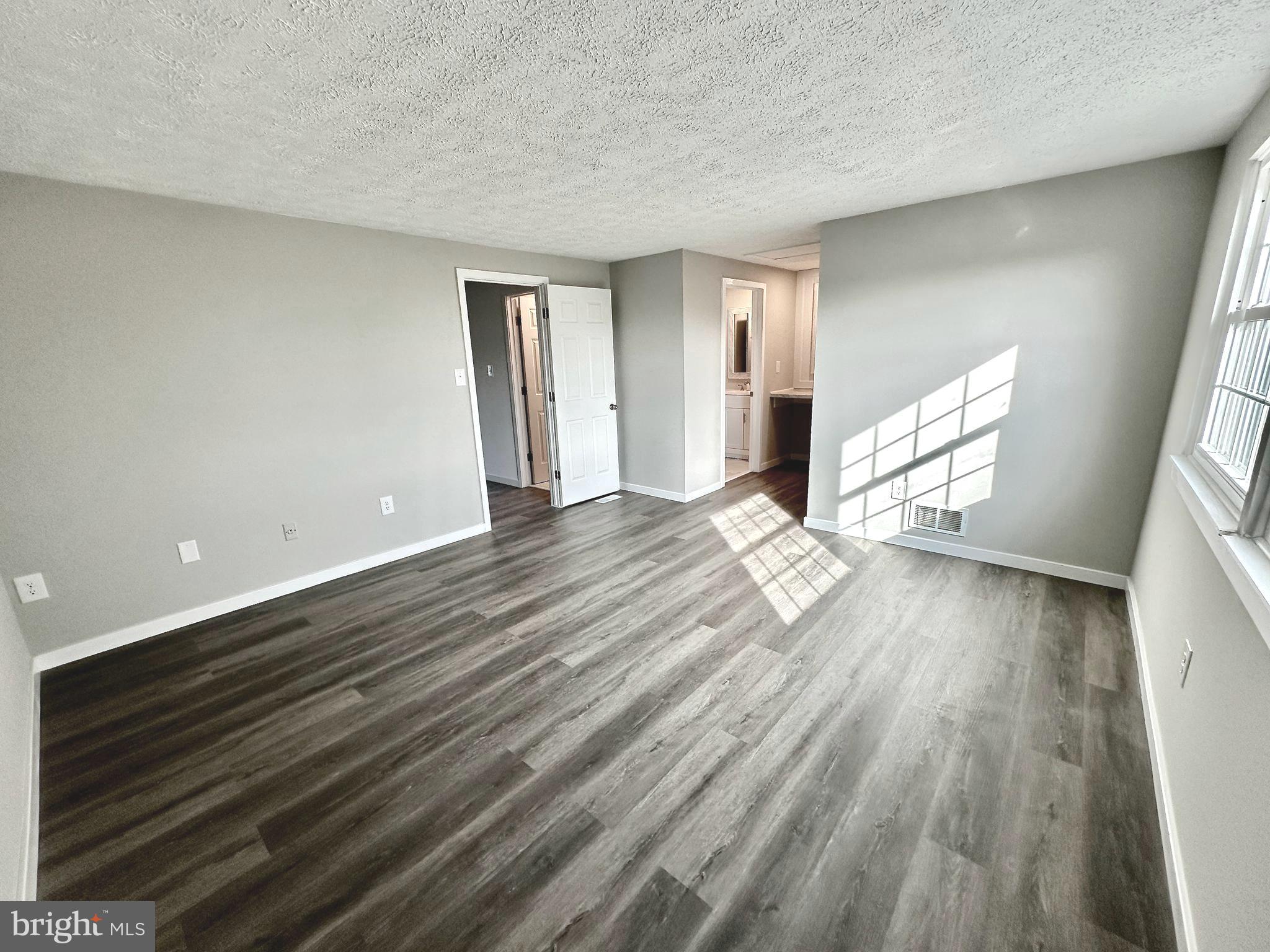 1776 Springfield Lane Frederick, MD 21702 - Photo 39 of 56 a view of an empty room with wooden floor and a window