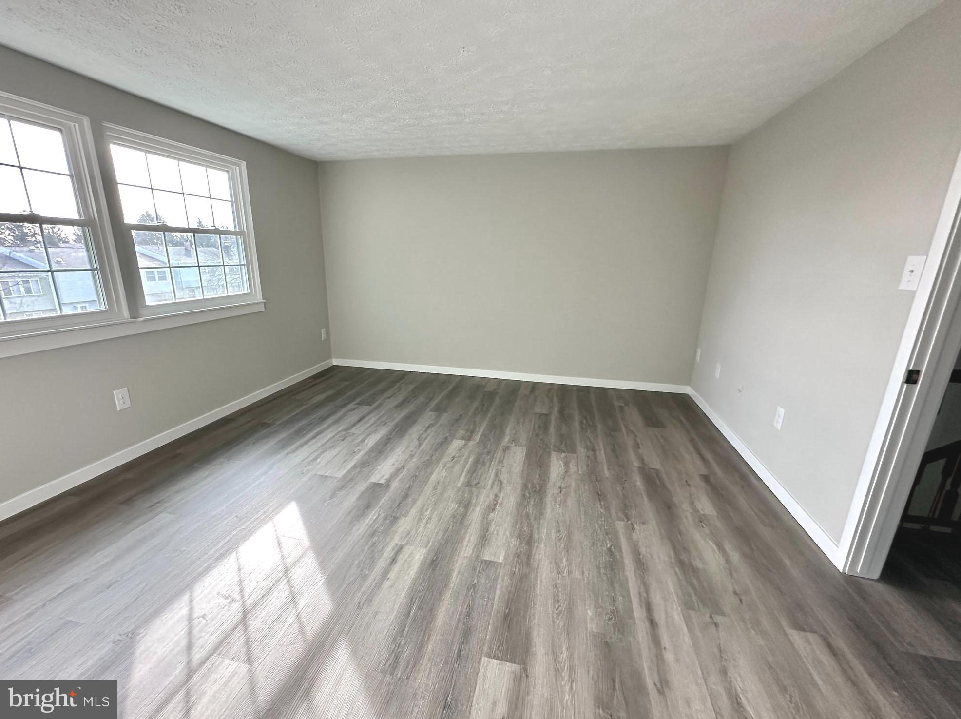 1776 Springfield Lane Frederick, MD 21702 - Photo 40 of 56 an empty room with wooden floor and windows