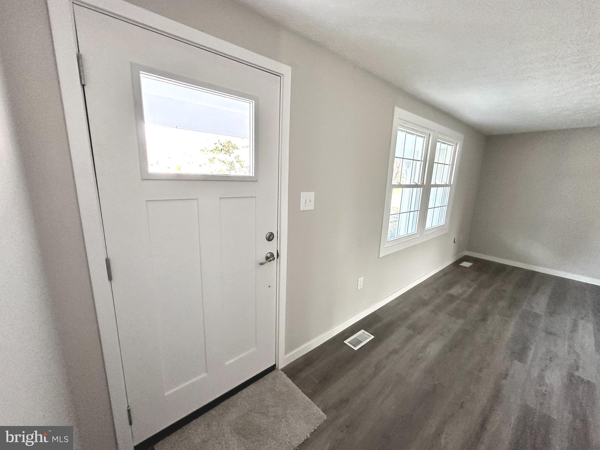 1776 Springfield Lane Frederick, MD 21702 - Photo 4 of 56 an empty room with wooden floor and windows