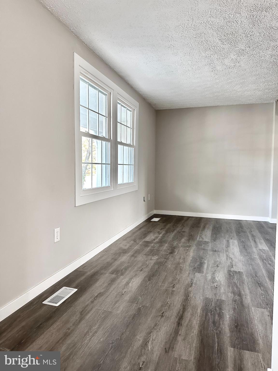 1776 Springfield Lane Frederick, MD 21702 - Photo 7 of 56 an empty room with wooden floor and windows