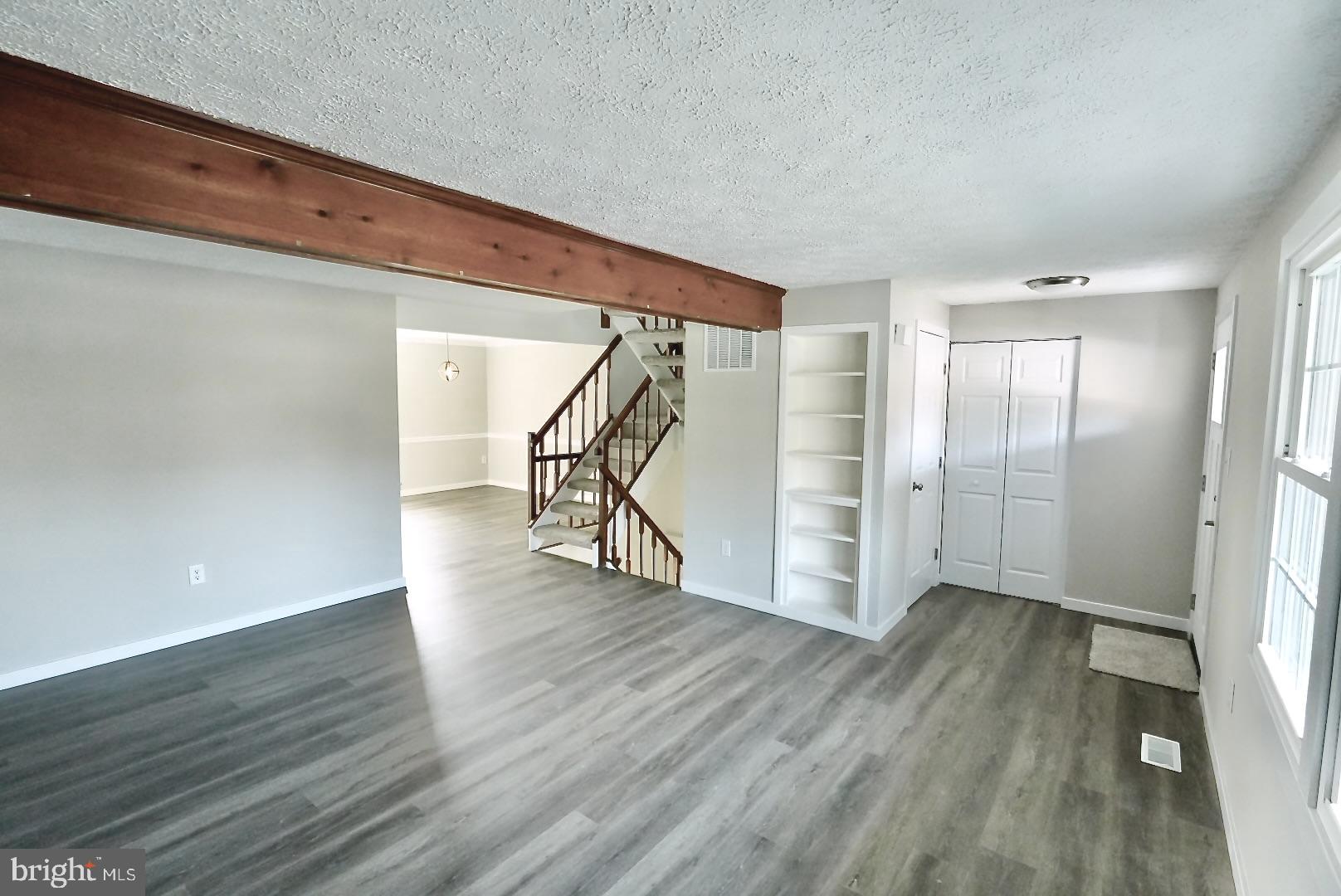1776 Springfield Lane Frederick, MD 21702 - Photo 10 of 56 a view of an empty room with wooden floor and stairs
