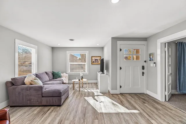 a dining room with furniture a rug and wooden floor