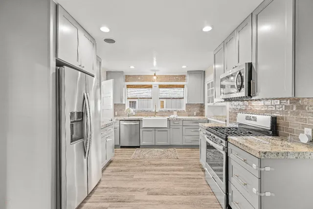 a kitchen with a stove a sink and a refrigerator