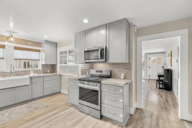 a stove top oven sitting inside of a kitchen